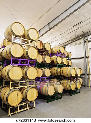 Stock Image - Wine barrels on racks in cellar. Fotosearch