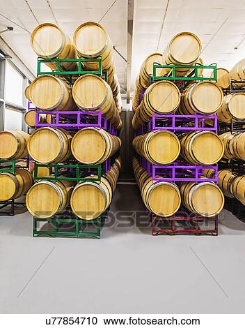 Stock Image - Wine barrels on racks in cellar. Fotosearch