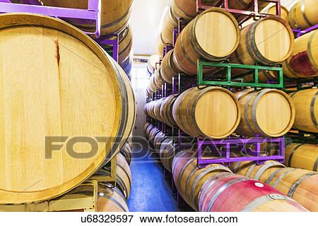 Stock Photo - Wine barrels on racks in cellar. Fotosearch