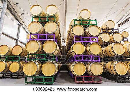 Wine barrels on racks in cellar View Large Photo Image Stock Photography - Wine barrels on racks in cellar. Fotosearch