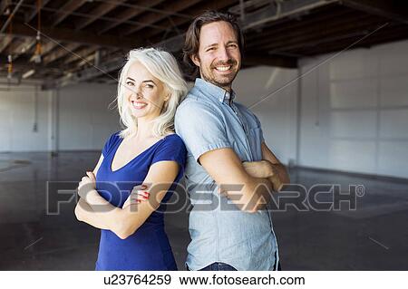 Woman and man standing in warehouse View Large Photo Image Stock Photo - Woman and man standing in warehouse. Fotosearch