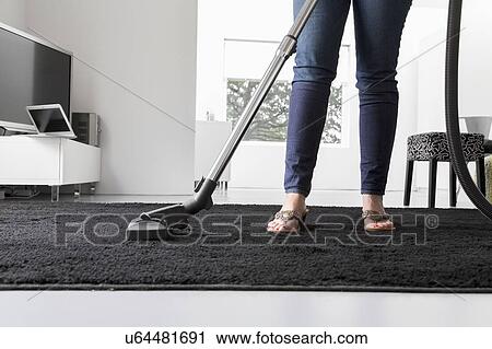 Stock Image - Woman cleaning house. Fotosearch