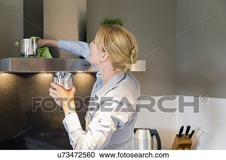 Stock Image - Woman cleaning house. Fotosearch