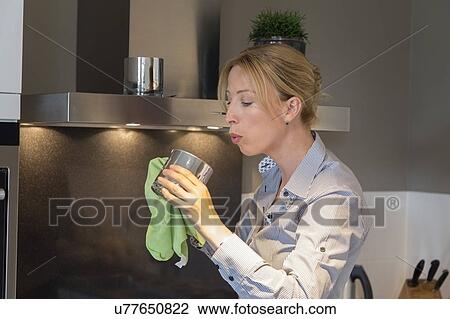 Stock Image - Woman cleaning house. Fotosearch