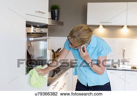 Stock Image - Woman cleaning house. Fotosearch