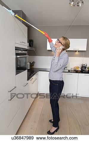 Stock Photo - Woman cleaning house. Fotosearch