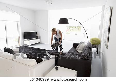 Woman cleaning living room View Large Photo Image Stock Photo - Woman cleaning living room. Fotosearch