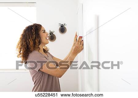 Woman decorating room View Large Photo Image Stock Image - Woman decorating room. Fotosearch