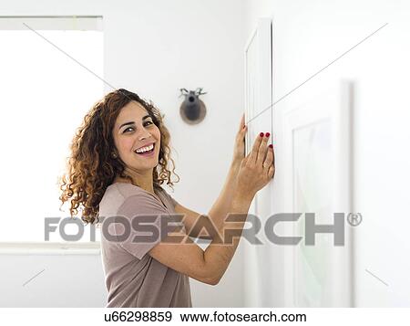 Woman decorating room View Large Photo Image Stock Photo - Woman decorating room. Fotosearch