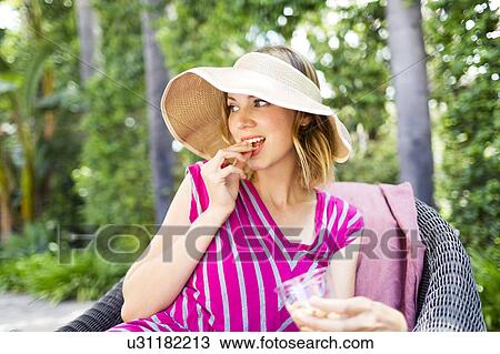 Woman eating snacks View Large Photo Image Stock Image - Woman eating snacks. Fotosearch