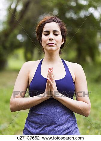 Stock Image - Woman exercising outdoors. Fotosearch