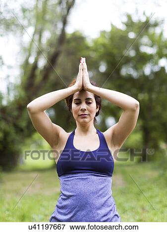 Woman exercising outdoors View Large Photo Image Stock Photo - Woman exercising outdoors. Fotosearch