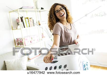 Stock Image - Woman holding box. Fotosearch
