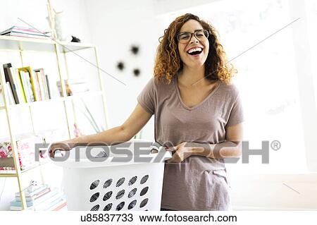 Stock Image - Woman holding box. Fotosearch