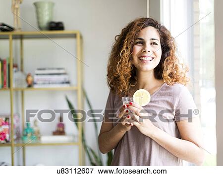 Woman holding drinking glass View Large Photo Image Stock Photo - Woman holding drinking glass. Fotosearch