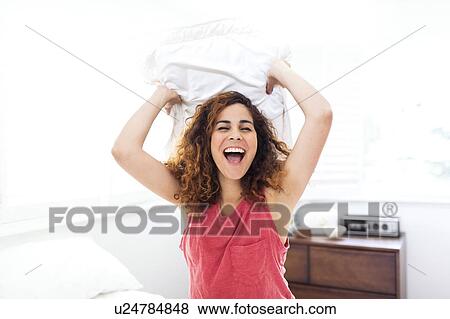 Stock Photo - Woman holding pillow. Fotosearch