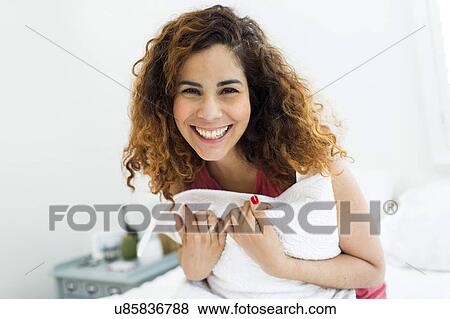 Stock Photo - Woman holding pillow. Fotosearch