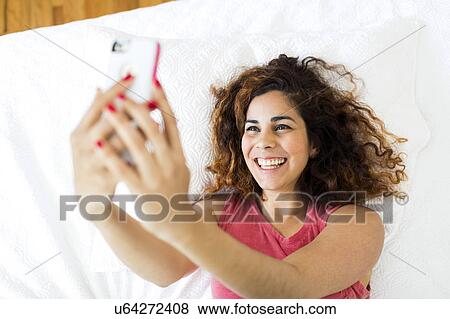Woman holding smart phone View Large Photo Image Stock Photo - Woman holding smart phone. Fotosearch