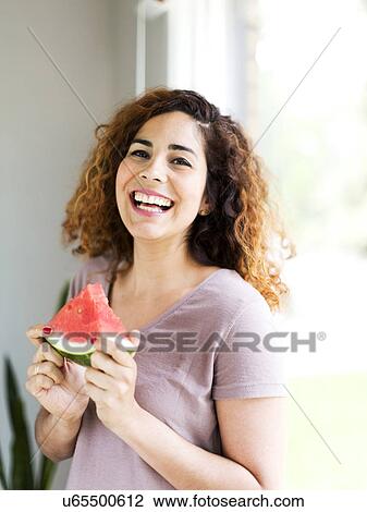 Stock Image - Woman holding water melon. Fotosearch