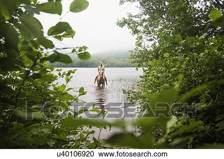 Woman horseback riding in countryside View Large Photo Image Stock Image - Woman horseback riding in countryside. Fotosearch