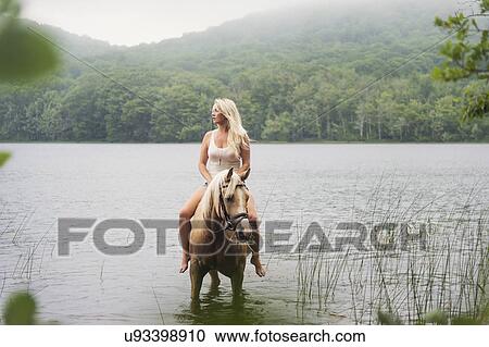 Woman horseback riding in countryside View Large Photo Image Stock Image - Woman horseback riding in countryside. Fotosearch