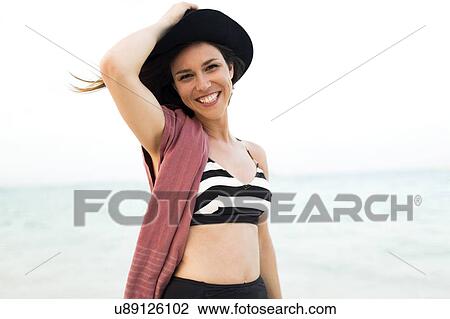 Woman in bikini relaxing on beach View Large Photo Image Stock Image - Woman in bikini relaxing on beach. Fotosearch