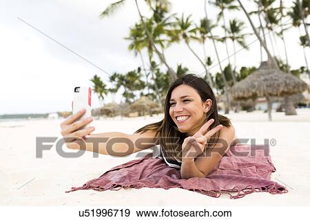 Woman in bikini relaxing on beach View Large Photo Image Stock Photo - Woman in bikini relaxing on beach. Fotosearch