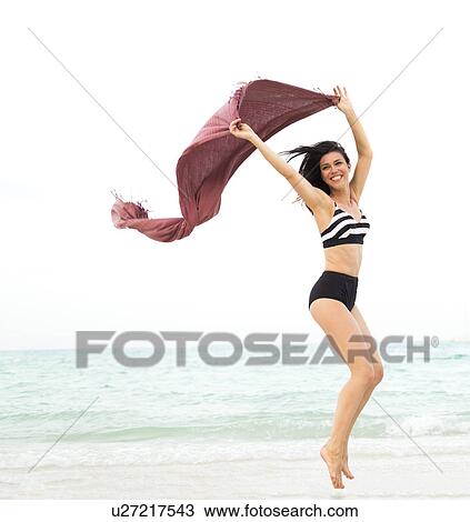 Woman jumping on beach View Large Photo Image Stock Image - Woman jumping on beach. Fotosearch