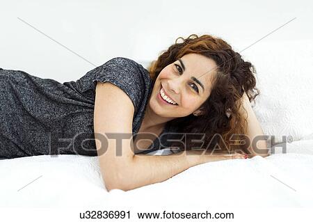 Woman lying in bed View Large Photo Image Stock Image - Woman lying in bed. Fotosearch