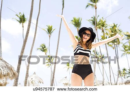 Woman on beach against palm trees View Large Photo Image Stock Photo - Woman on beach against palm trees. Fotosearch