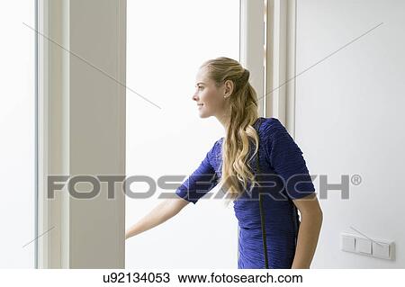 Woman opening door View Large Photo Image Stock Image - Woman opening door. Fotosearch