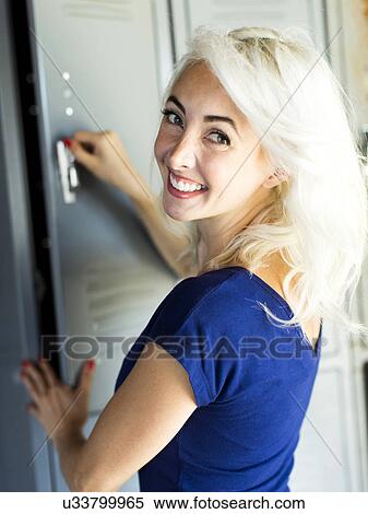 Woman opening locker View Large Photo Image Stock Photography - Woman opening locker. Fotosearch