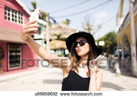 Stock Image - Woman photographing self. Fotosearch