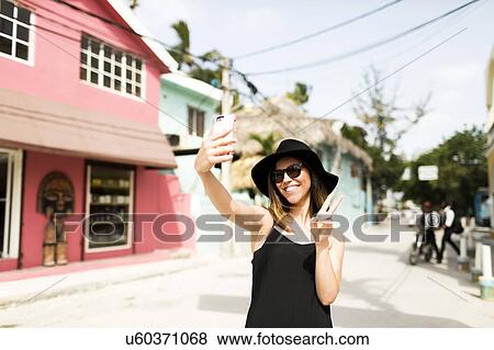Stock Photo - Woman photographing self. Fotosearch