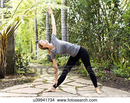 Woman practicing yoga View Large Photo Image Picture - Woman practicing yoga. Fotosearch