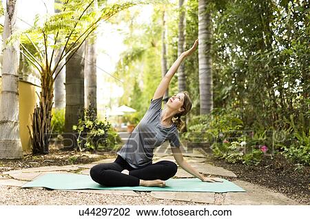 Stock Image - Woman practicing yoga. Fotosearch