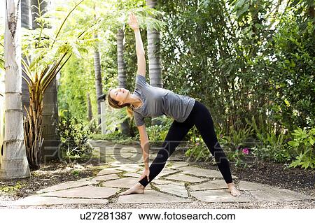 Stock Photo - Woman practicing yoga. Fotosearch