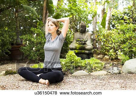 Stock Photo - Woman practicing yoga. Fotosearch