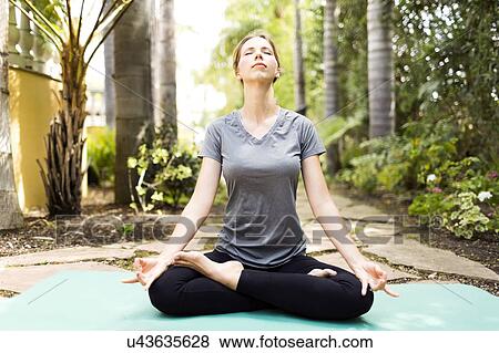 Stock Photo - Woman practicing yoga. Fotosearch