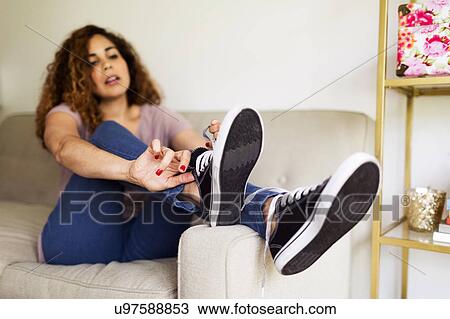Woman putting on trainers View Large Photo Image Stock Image - Woman putting on trainers. Fotosearch