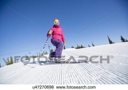 Stock Photo - Woman skiing downhill. Fotosearch