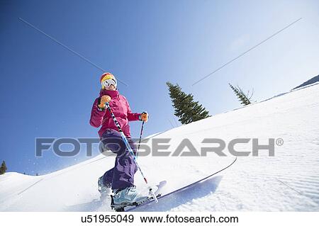 Stock Photo - Woman skiing downhill. Fotosearch