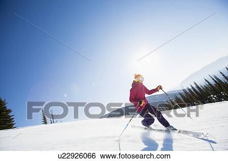 Stock Photograph - Woman skiing downhill. Fotosearch