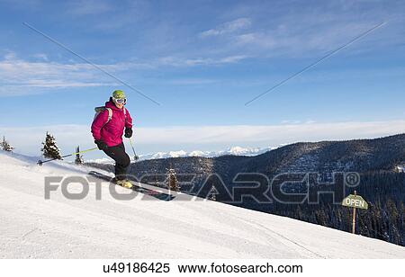 Woman skiing downhill View Large Photo Image Stock Photography - Woman skiing downhill. Fotosearch