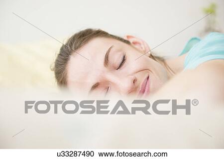 Stock Image - Woman smiling in sleep. Fotosearch