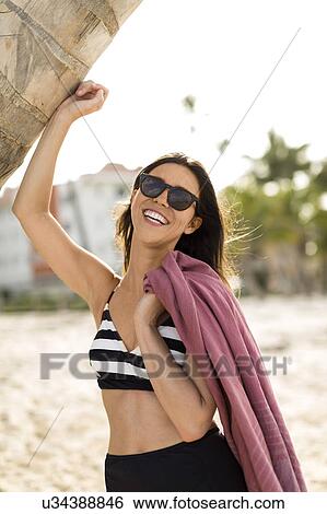 Woman smiling on beach View Large Photo Image Stock Photograph - Woman smiling on beach. Fotosearch