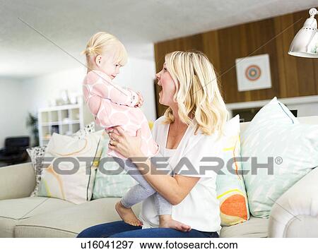 Woman spending time with daughter (2-3) in living room View Large Photo Image Stock Photo - Woman spending time with daughter (2-3) in living room. Fotosearch