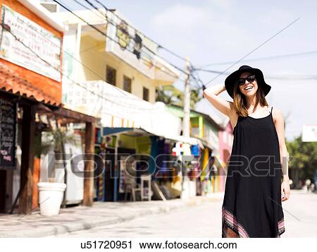 Stock Image - Woman standing in street. Fotosearch