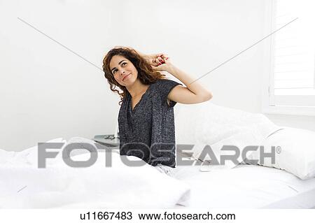 Woman stretching in bed View Large Photo Image Stock Image - Woman stretching in bed. Fotosearch
