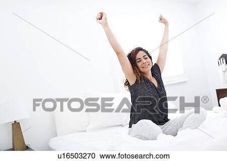Woman stretching in bed View Large Photo Image Stock Image - Woman stretching in bed. Fotosearch